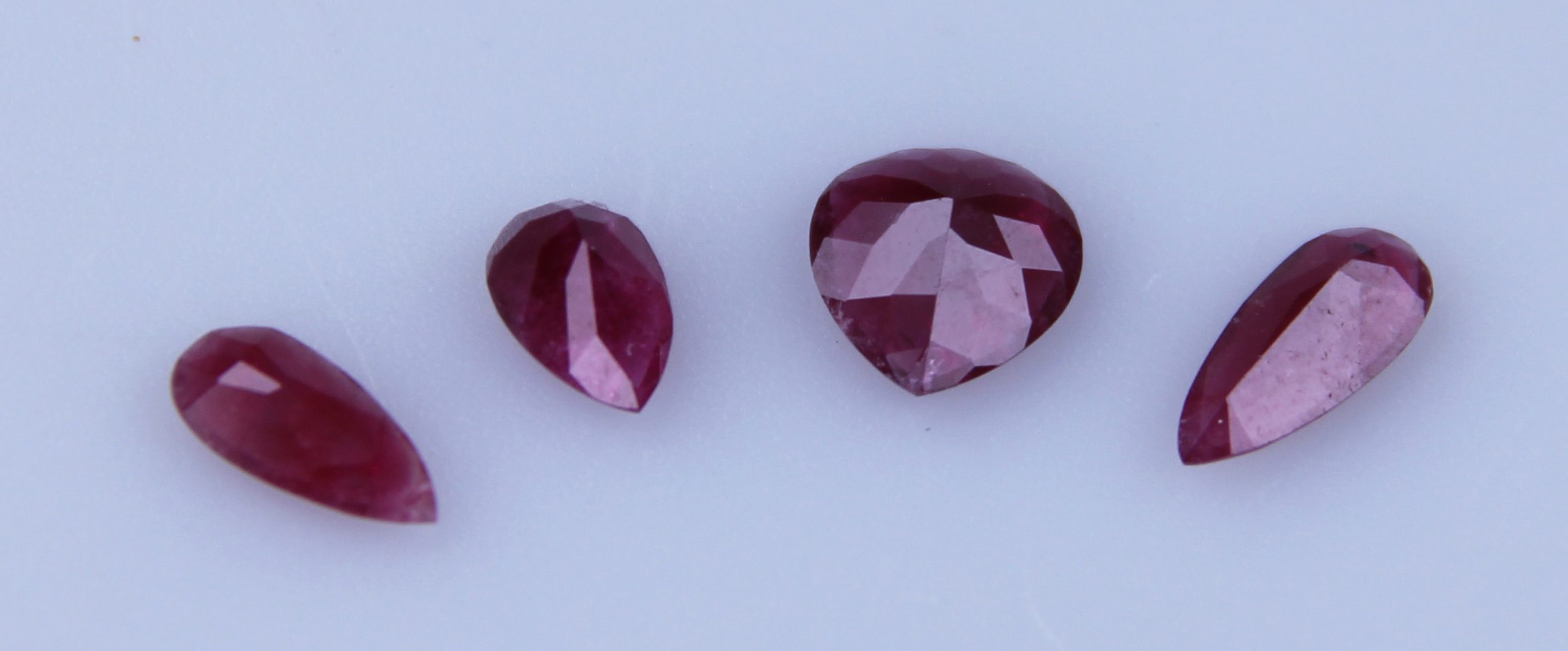 Gemstone Discoveries: What Is the Likeliness of Finding a ‘New’ Gemstone? - - A group of red beryl pear shaped gemstones